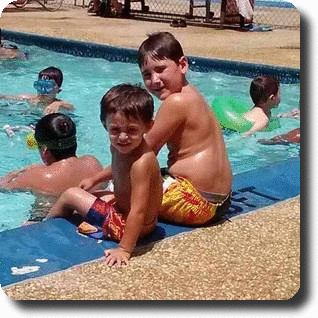 boys sitting by pool